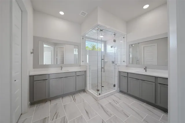 a large bathroom with a large mirror vanity and shower