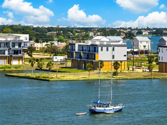 an aerial view of a houses with ocean view