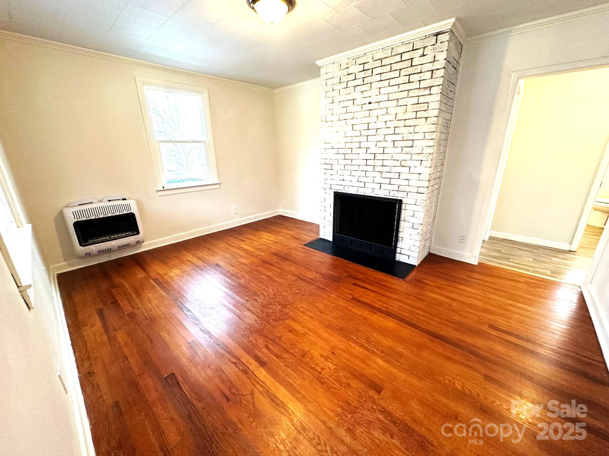 170 Proctor School Road Mooresboro, NC 28114 - Photo 11 of 32 an empty room with wooden floor and windows