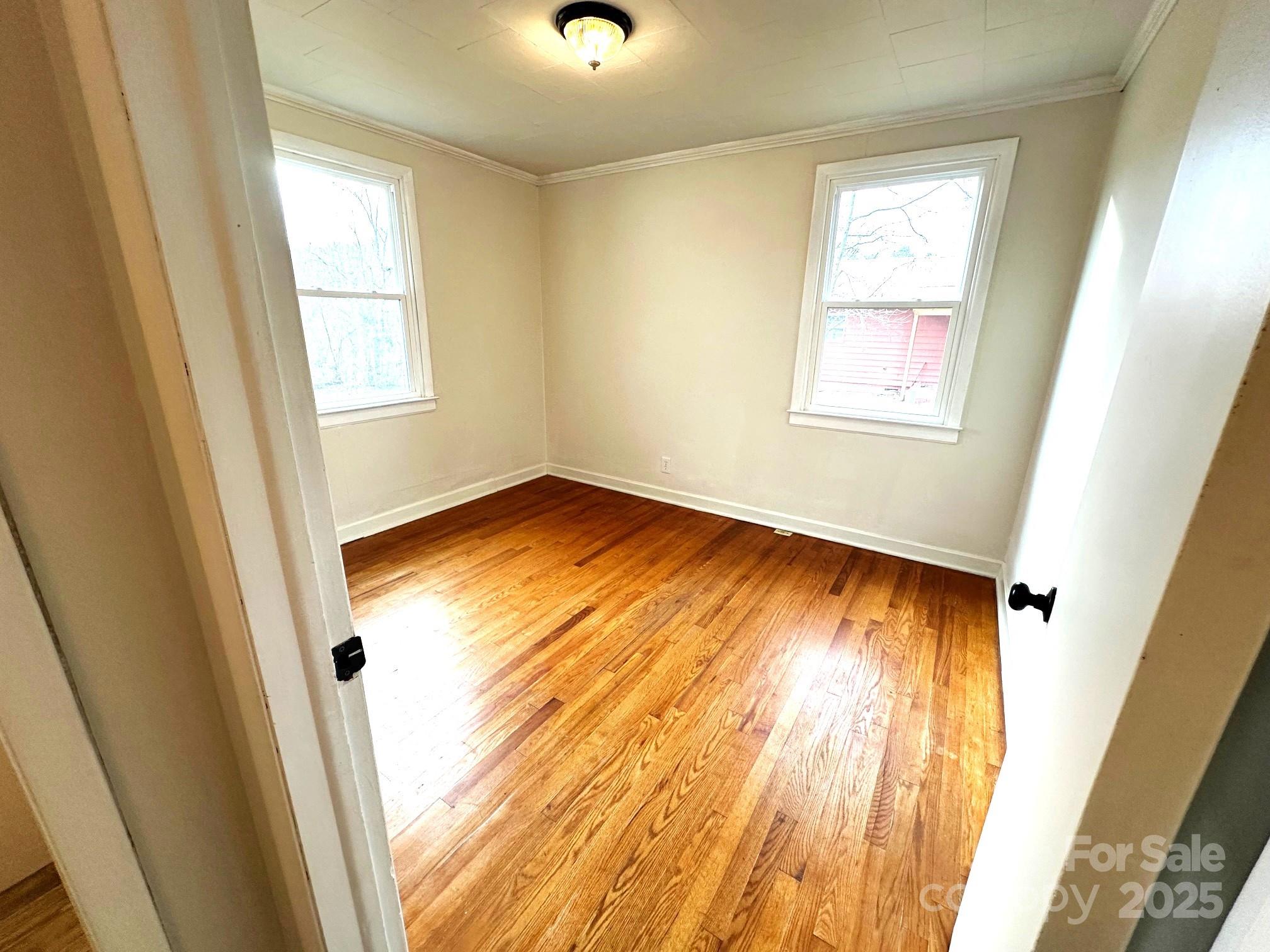 170 Proctor School Road Mooresboro, NC 28114 - Photo 23 of 32 a view of an empty room with wooden floor and a window