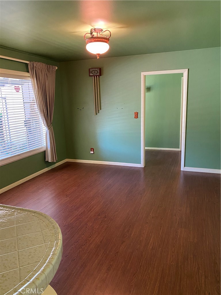 2805 Forist Lane Merced, CA 95340 - Photo 14 of 26 an empty room with wooden floor and windows
