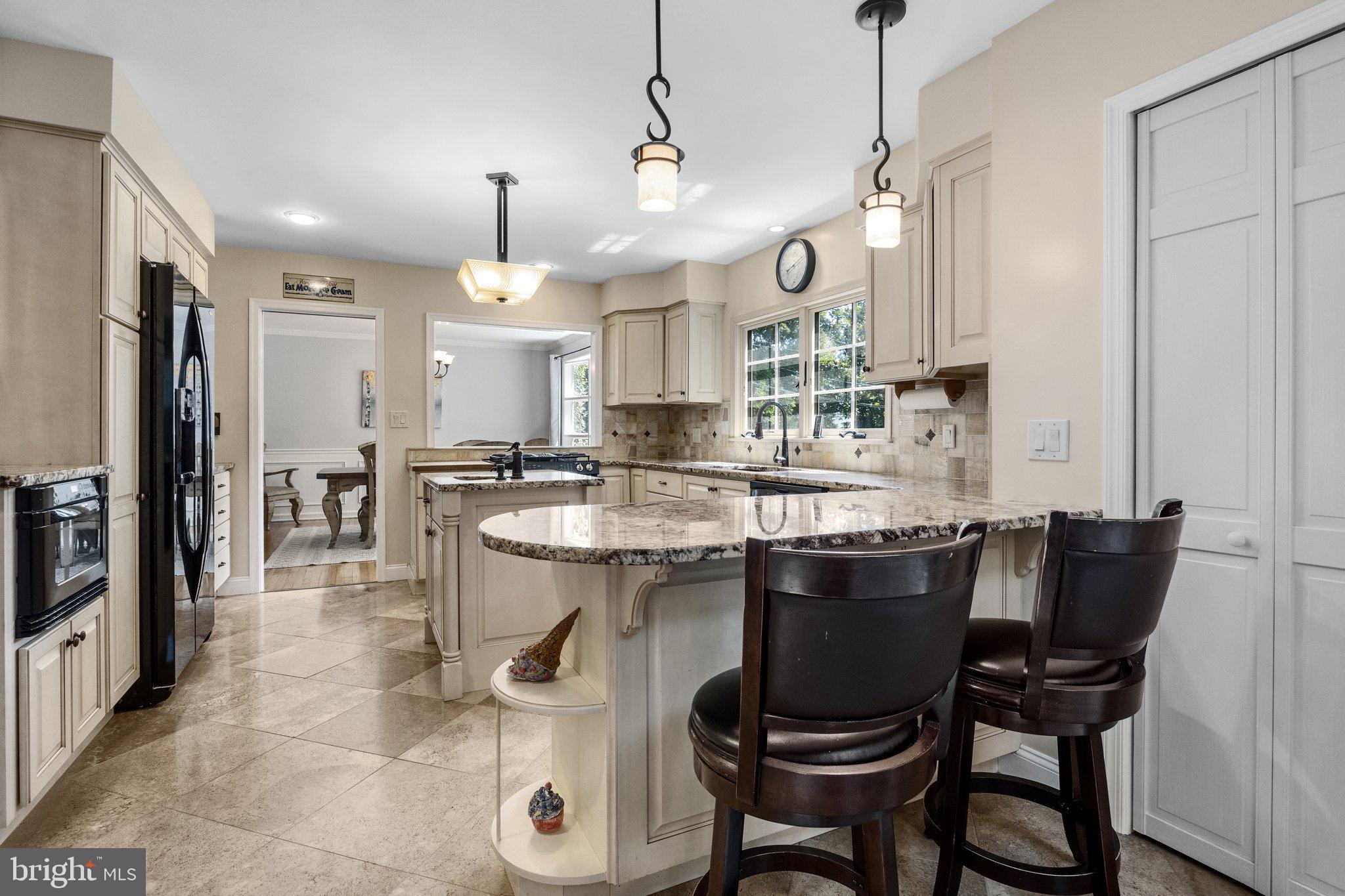 1313 Moon Drive Yardley, PA 19067 - Photo 18 of 56 a kitchen with kitchen island a dining table chairs stainless steel appliances and cabinets