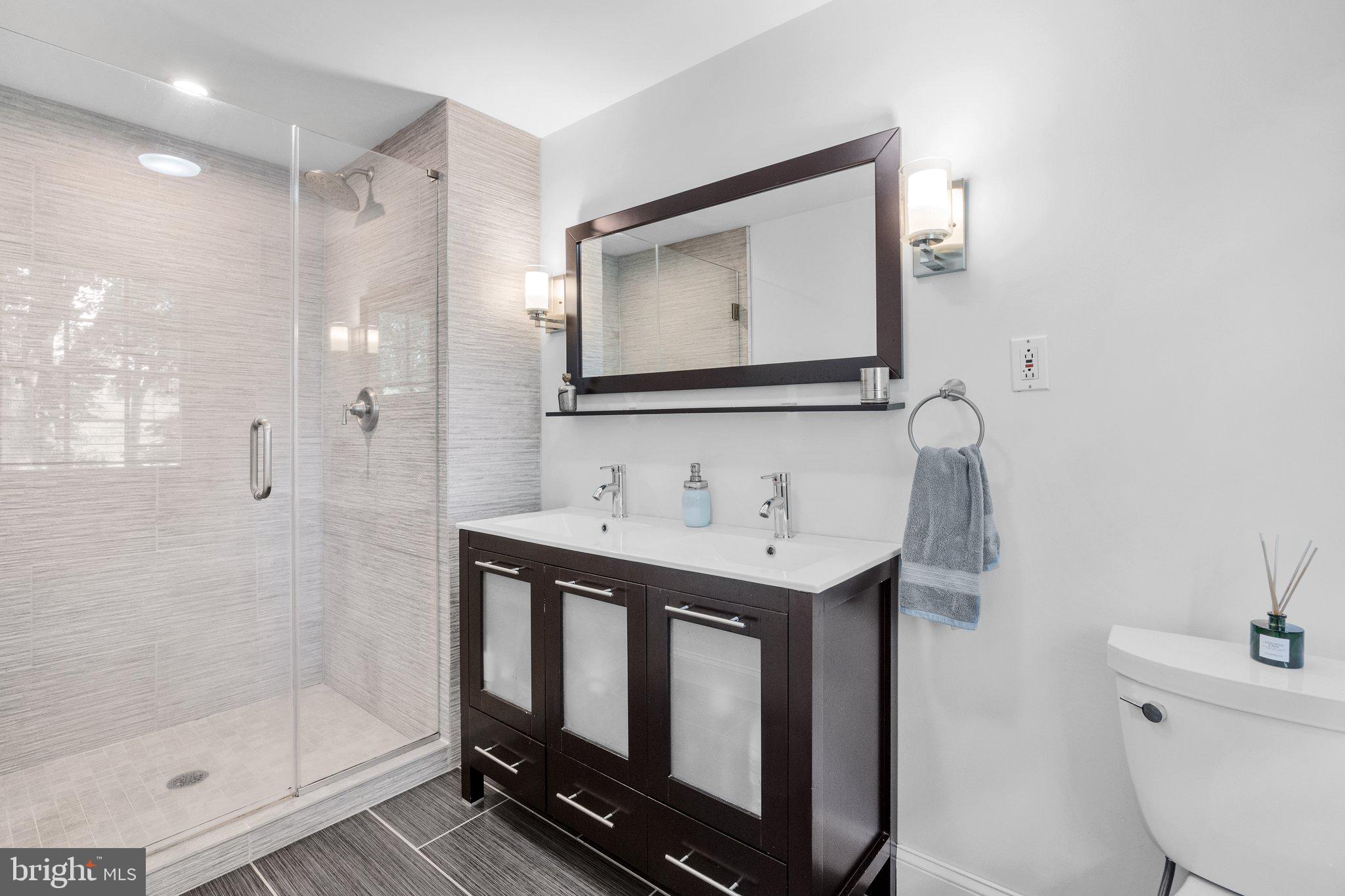 1313 Moon Drive Yardley, PA 19067 - Photo 30 of 56 a bathroom with a sink a toilet a mirror and shower