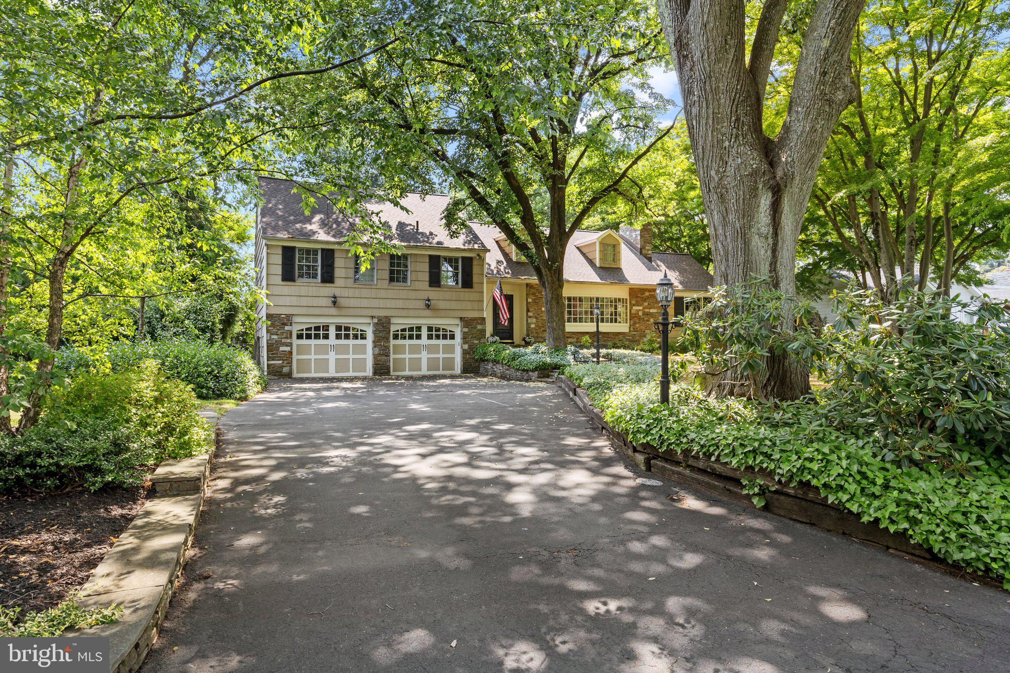 1313 Moon Drive Yardley, PA 19067 - Photo 4 of 56 a view of a yard in front of a house with large trees