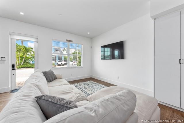 53 Southeast Seminole Street, Unit 2B Stuart, FL 34994 - Photo 11 of 31 a living room with a couch and a window