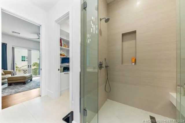 a view of walk in closet with clothes and shoes