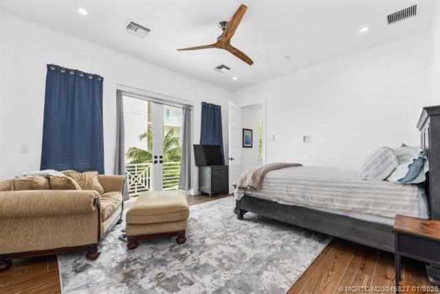 53 Southeast Seminole Street, Unit 2B Stuart, FL 34994 - Photo 19 of 31 a bedroom with a bed and a couch