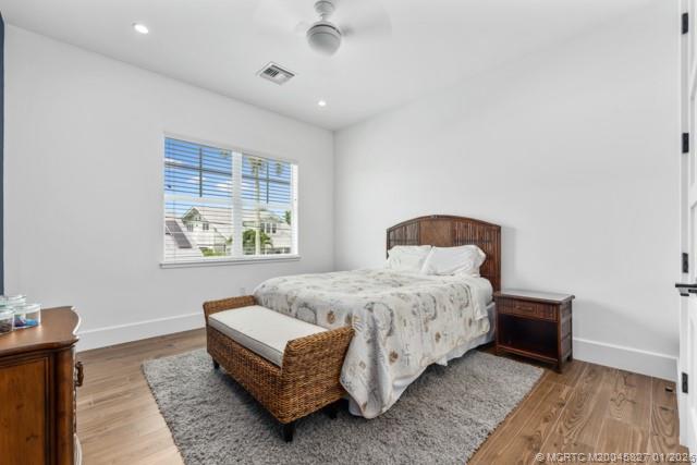 53 Southeast Seminole Street, Unit 2B Stuart, FL 34994 - Photo 24 of 31 a spacious bedroom with a bed and a window