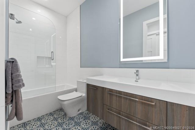 53 Southeast Seminole Street, Unit 2B Stuart, FL 34994 - Photo 27 of 31 a bathroom with a sink toilet and shower