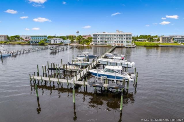 53 Southeast Seminole Street, Unit 2B Stuart, FL 34994 - Photo 30 of 31 a view of a lake with a table and chairs