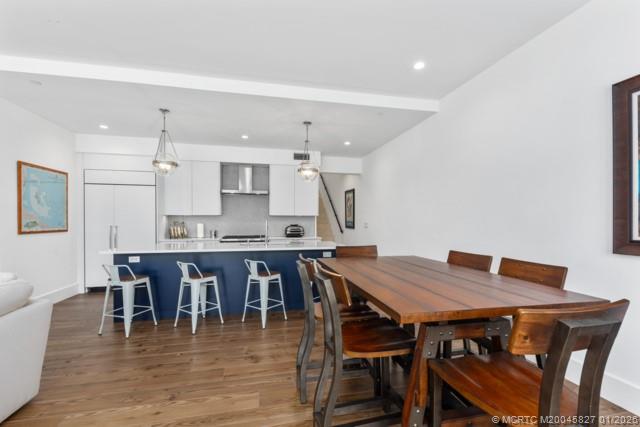 53 Southeast Seminole Street, Unit 2B Stuart, FL 34994 - Photo 9 of 31 a view of a dining room with furniture and wooden floor
