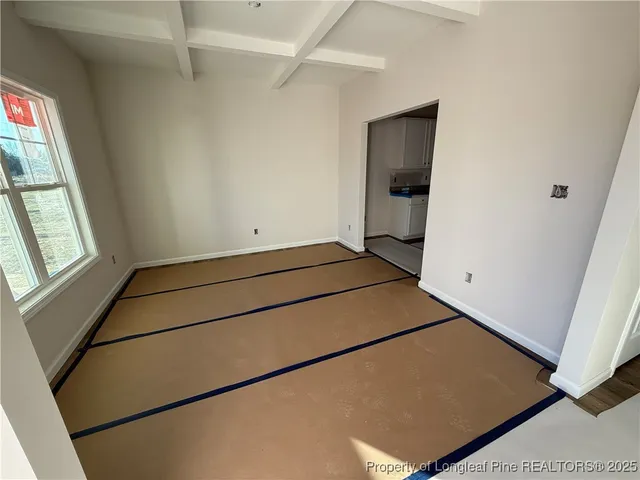 a large kitchen with kitchen island white cabinets and stainless steel appliances
