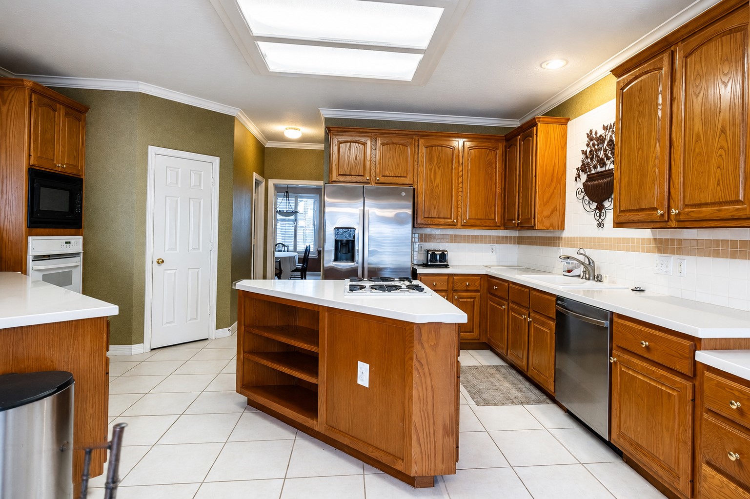 5718 Oakmoss Trail Spring, TX 77379 - Photo 13 of 47 Solid-surface counters with ample cabinet storage and seamless views into the family room.