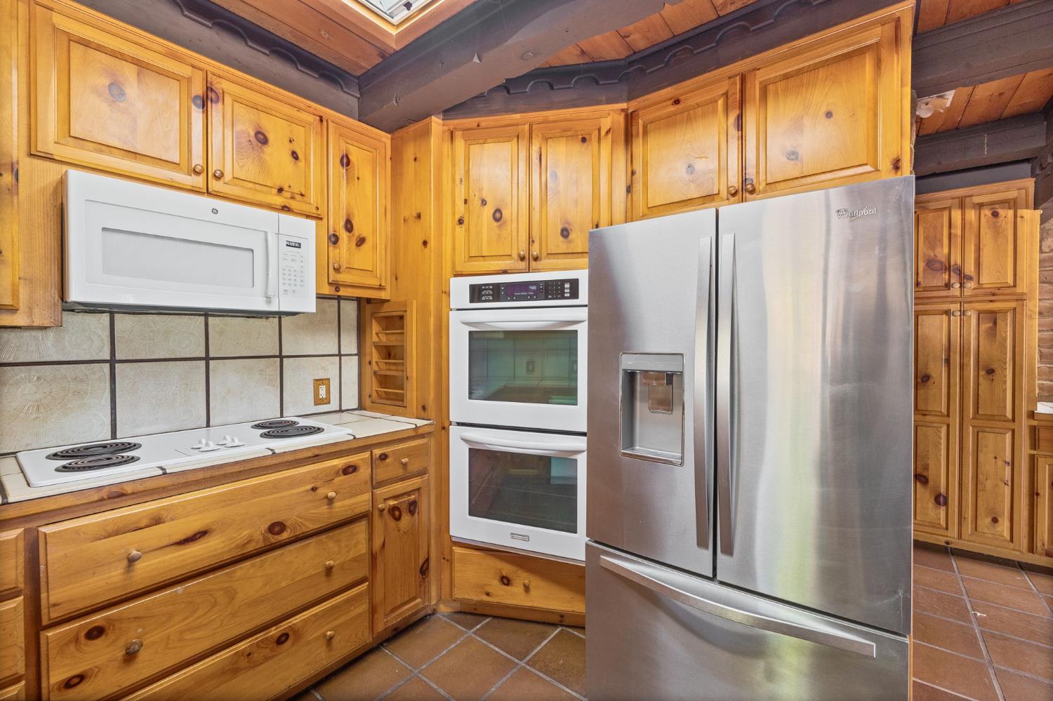 3981 Snow Creek Road Mariposa, CA 95338 - Photo 23 of 66 a kitchen with stainless steel appliances granite countertop a refrigerator and a stove