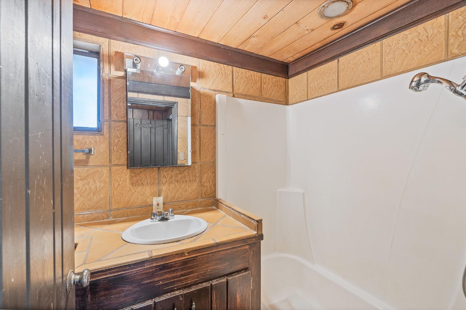 3981 Snow Creek Road Mariposa, CA 95338 - Photo 43 of 66 a bathroom with a sink and a mirror