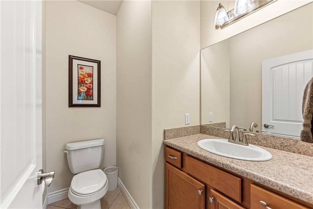 3315 Rainbow Mine Road Kingman, AZ 86401 - Photo 17 of 54 Well-appointed bathroom featuring a vanity with a light-colored countertop and wooden cabinetry, a large mirror, and overhead lighting