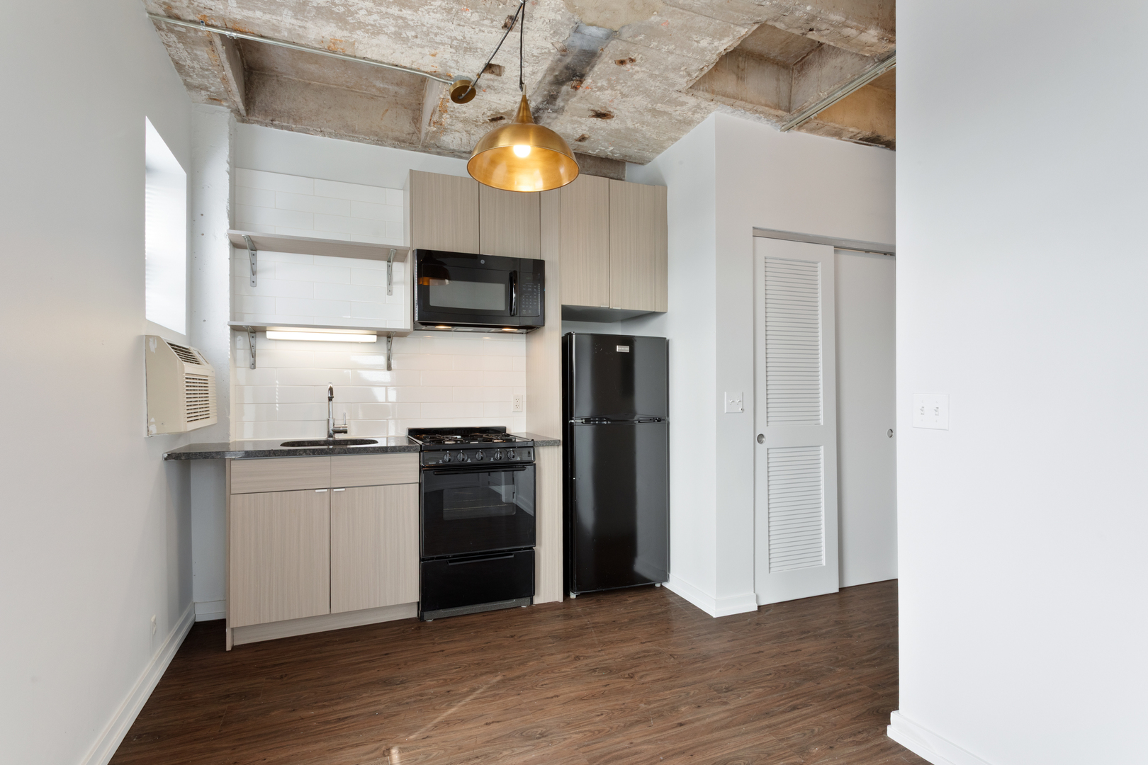 1325 West Wilson Avenue, Unit 601 Chicago, IL 60640 - Photo 6 of 19 a kitchen with stainless steel appliances a stove top oven a sink and a refrigerator
