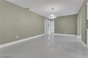 en empty room with window and hardwood floor