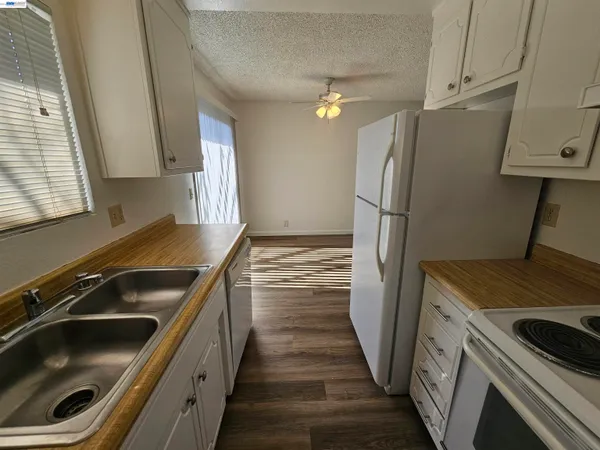 a kitchen with a sink stove and refrigerator