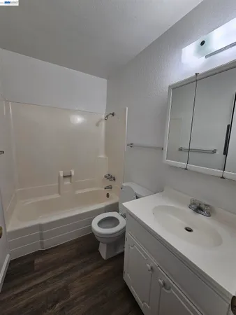 a white toilet sitting next to a sink