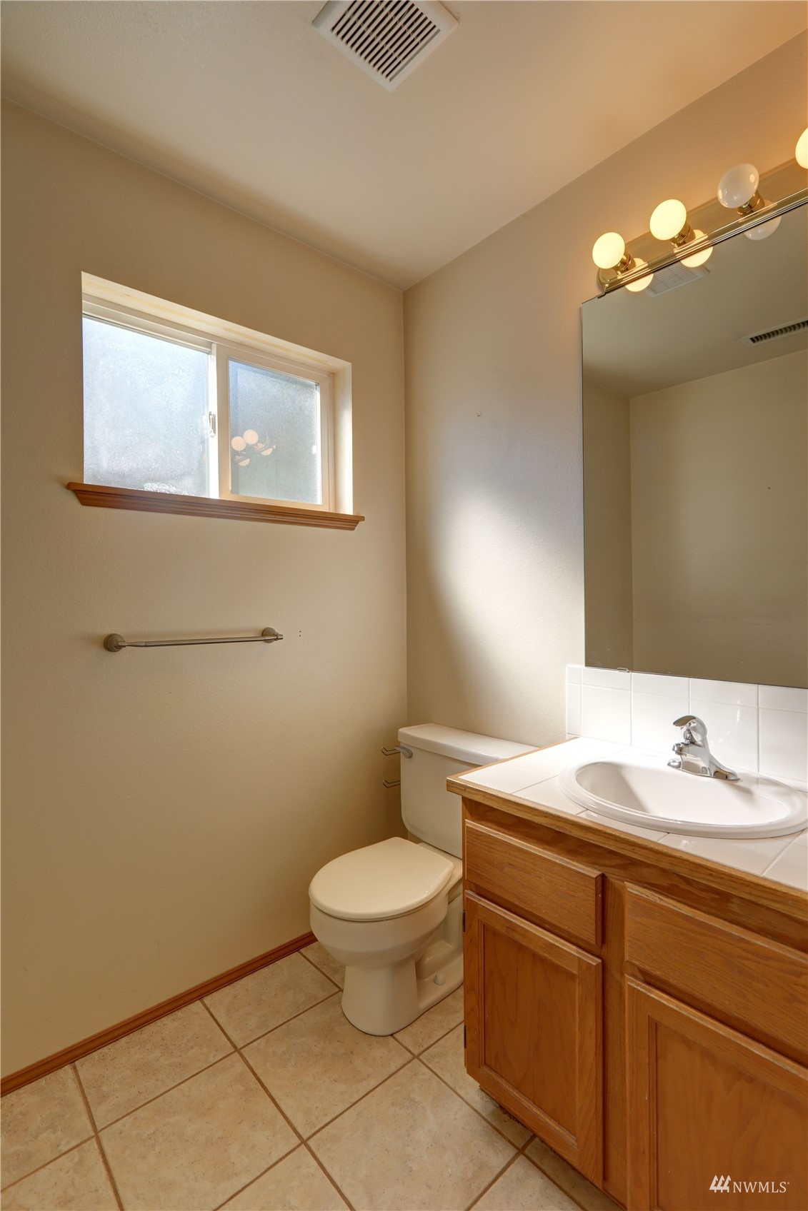 1635 Field Place Northeast Renton, WA 98059 - Photo 18 of 28 a bathroom with a sink toilet and vanity