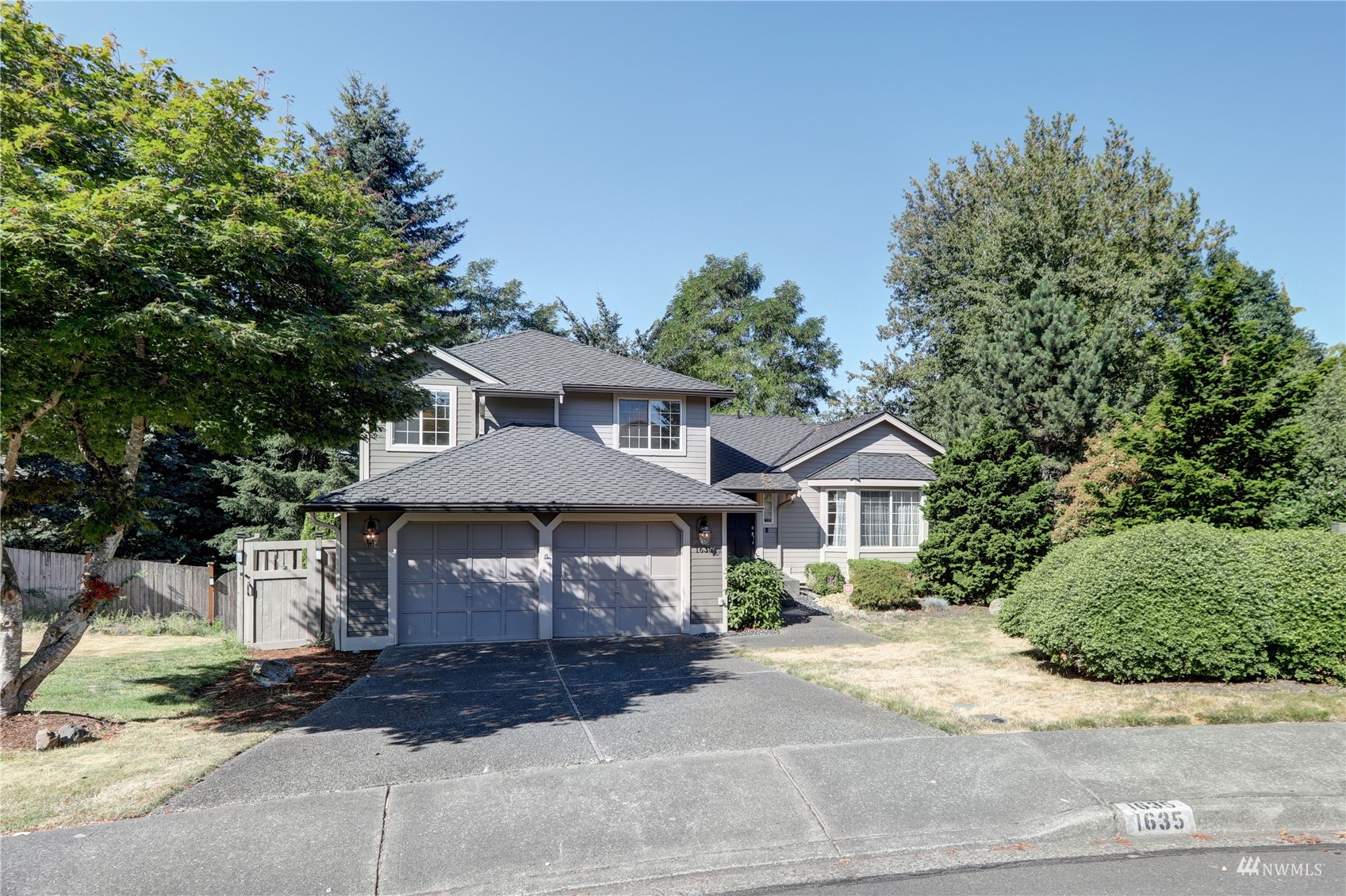 1635 Field Place Northeast Renton, WA 98059 - Photo 2 of 28 a front view of a house with a garden