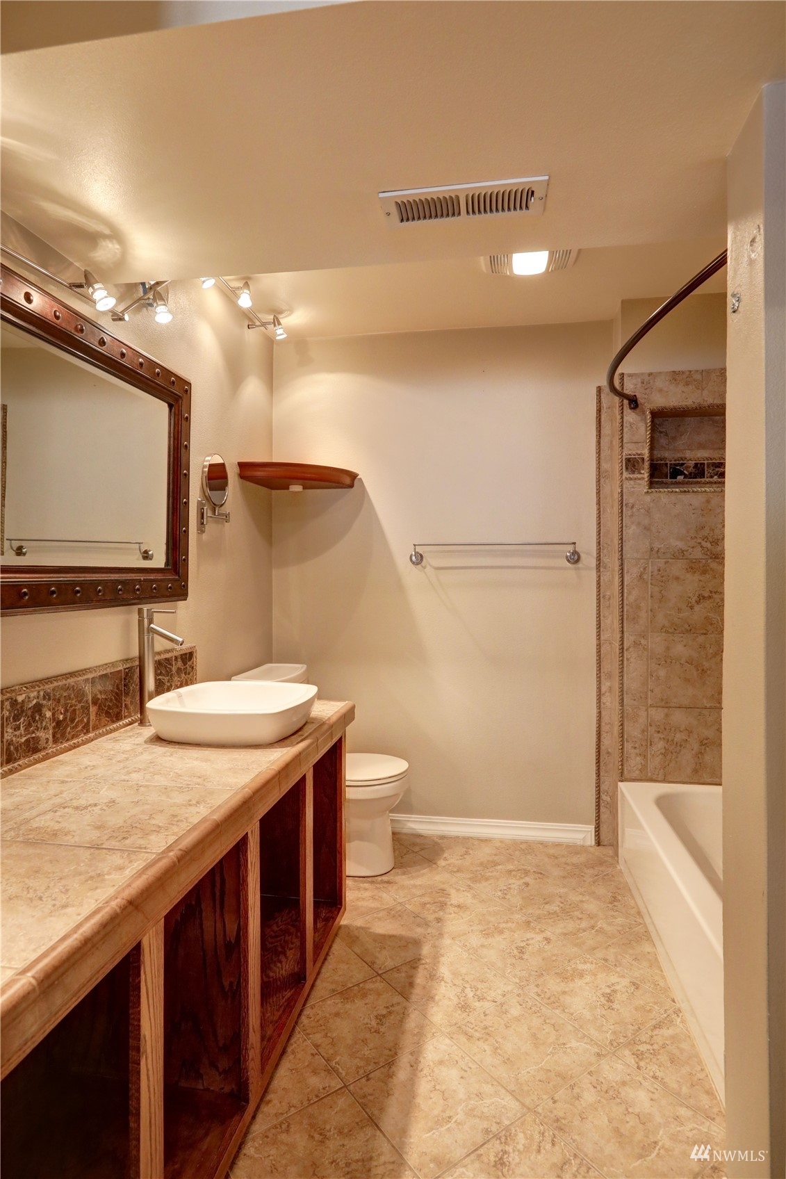 1635 Field Place Northeast Renton, WA 98059 - Photo 22 of 28 a bathroom with a granite countertop sink a toilet and a shower