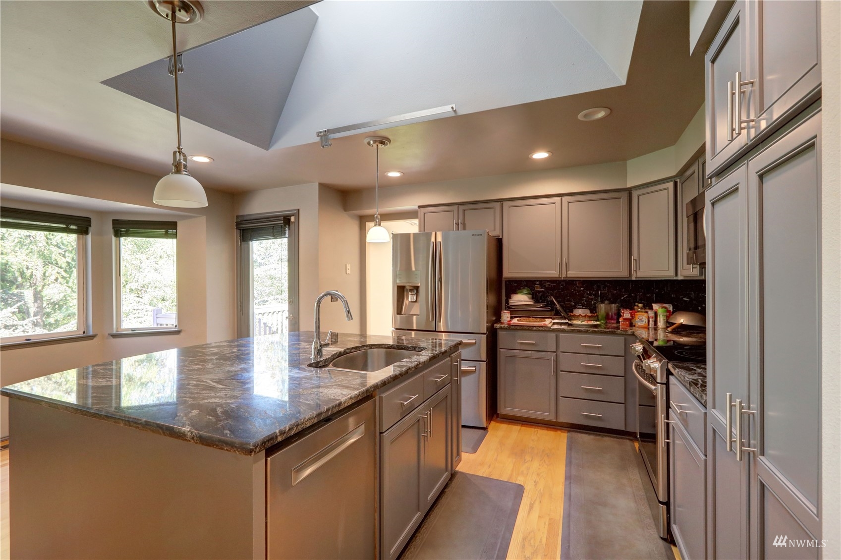 1635 Field Place Northeast Renton, WA 98059 - Photo 6 of 28 a kitchen with stainless steel appliances granite countertop a sink stove and refrigerator