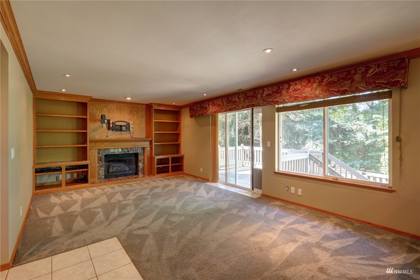 1635 Field Place Northeast Renton, WA 98059 - Photo 8 of 28 a view of an empty room with a fireplace and a large window