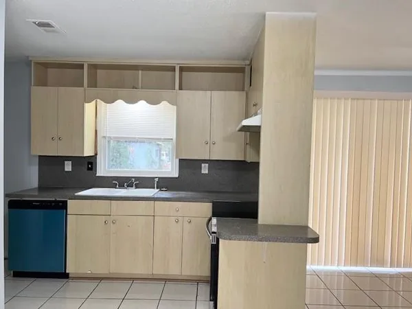 a kitchen with a stove a sink and a refrigerator