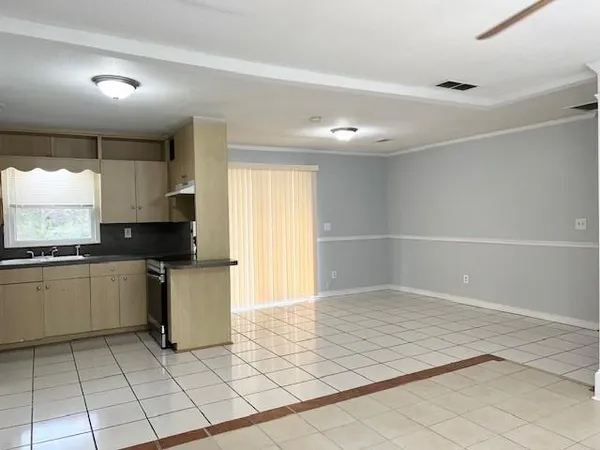 a kitchen with a sink a stove and cabinets
