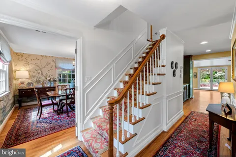 a view of entryway dining room and hall with wooden floor