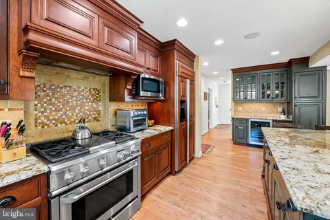 a kitchen with stainless steel appliances granite countertop a stove and a refrigerator