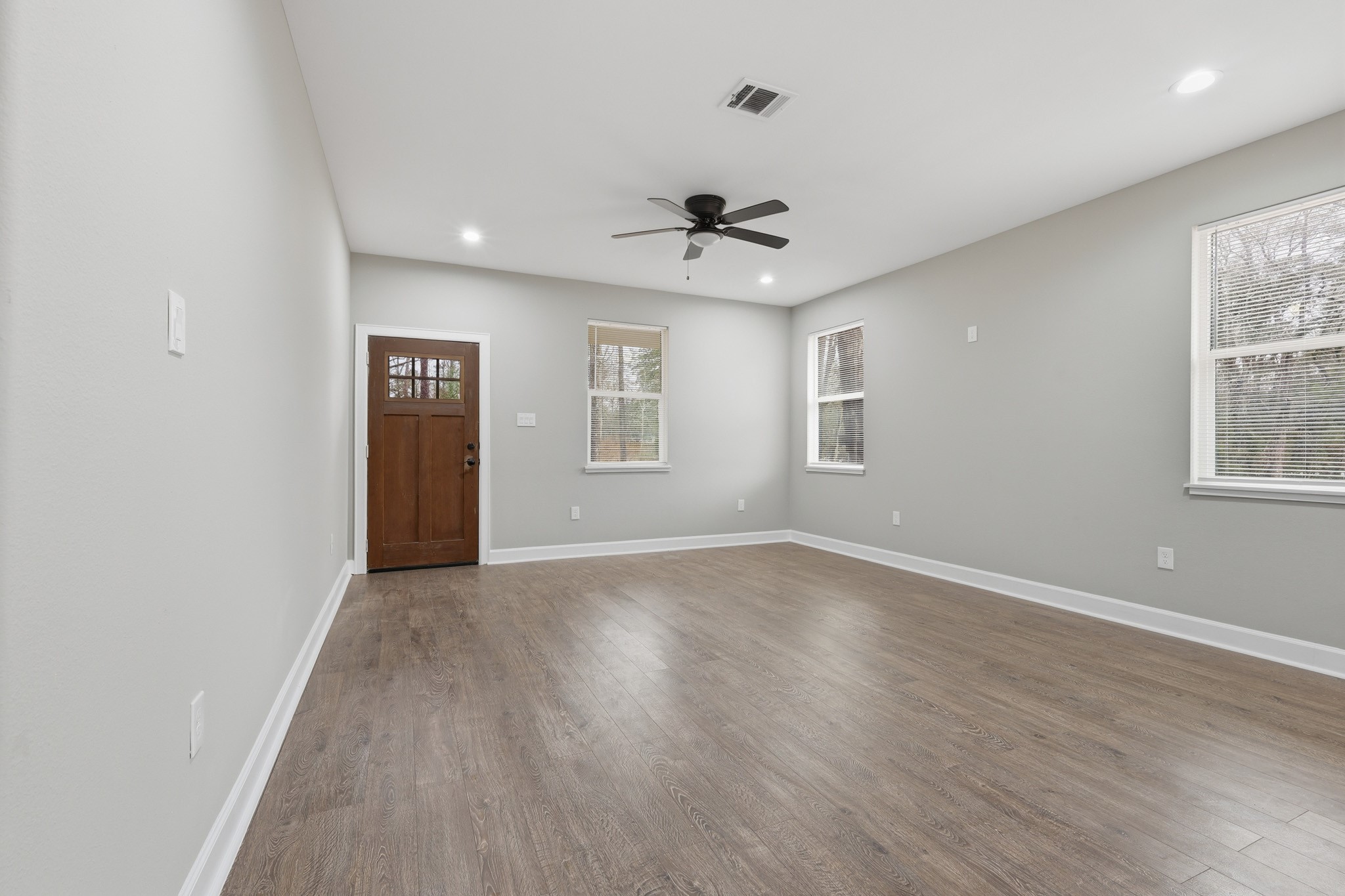 160 Oak Lane Shepherd, TX 77371 - Photo 5 of 15 a view of an empty room with a window and wooden floor
