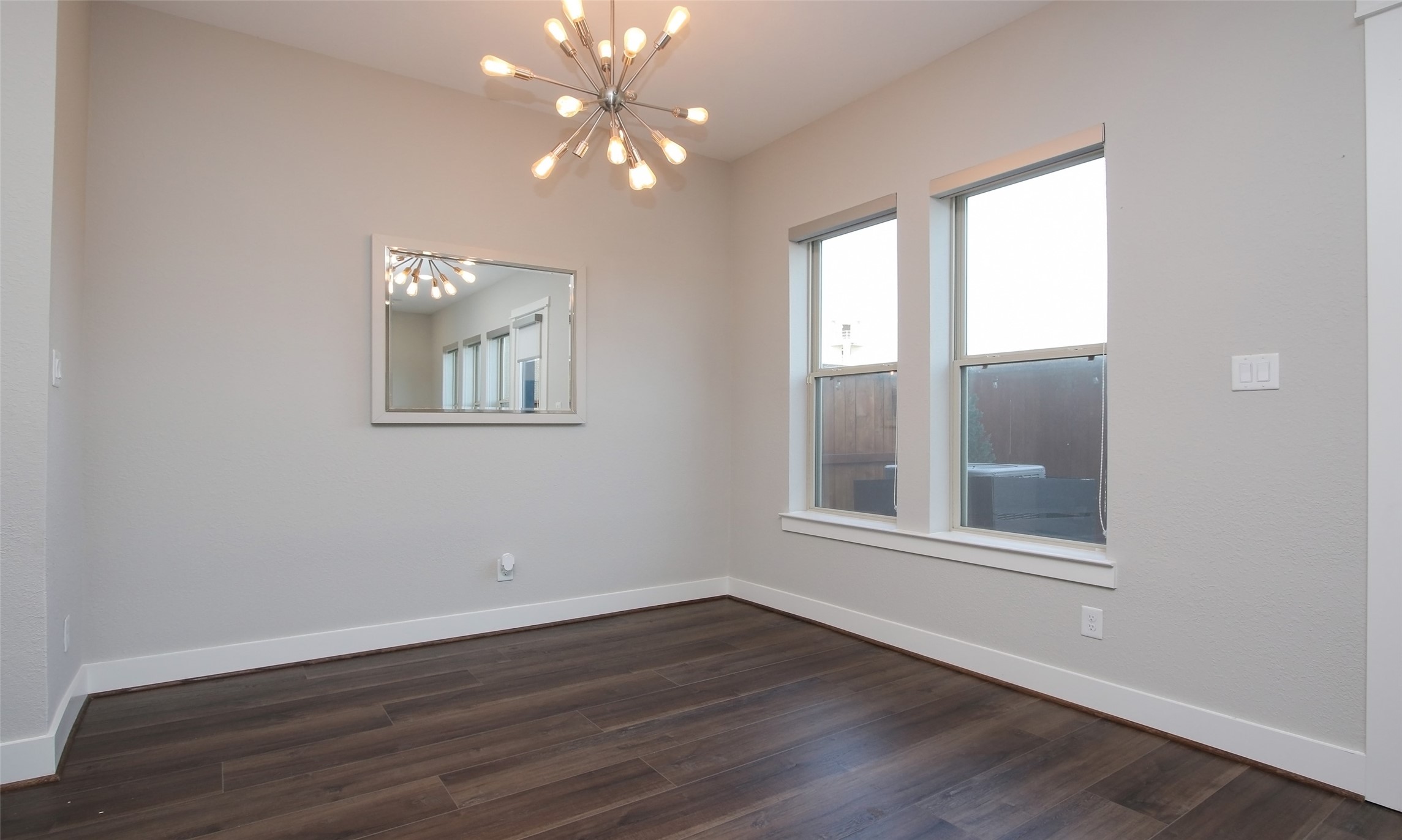 12502 Malachite Way Houston, TX 77077 - Photo 11 of 41 Dining room with modern upgraded light fixture and windows with solar shades