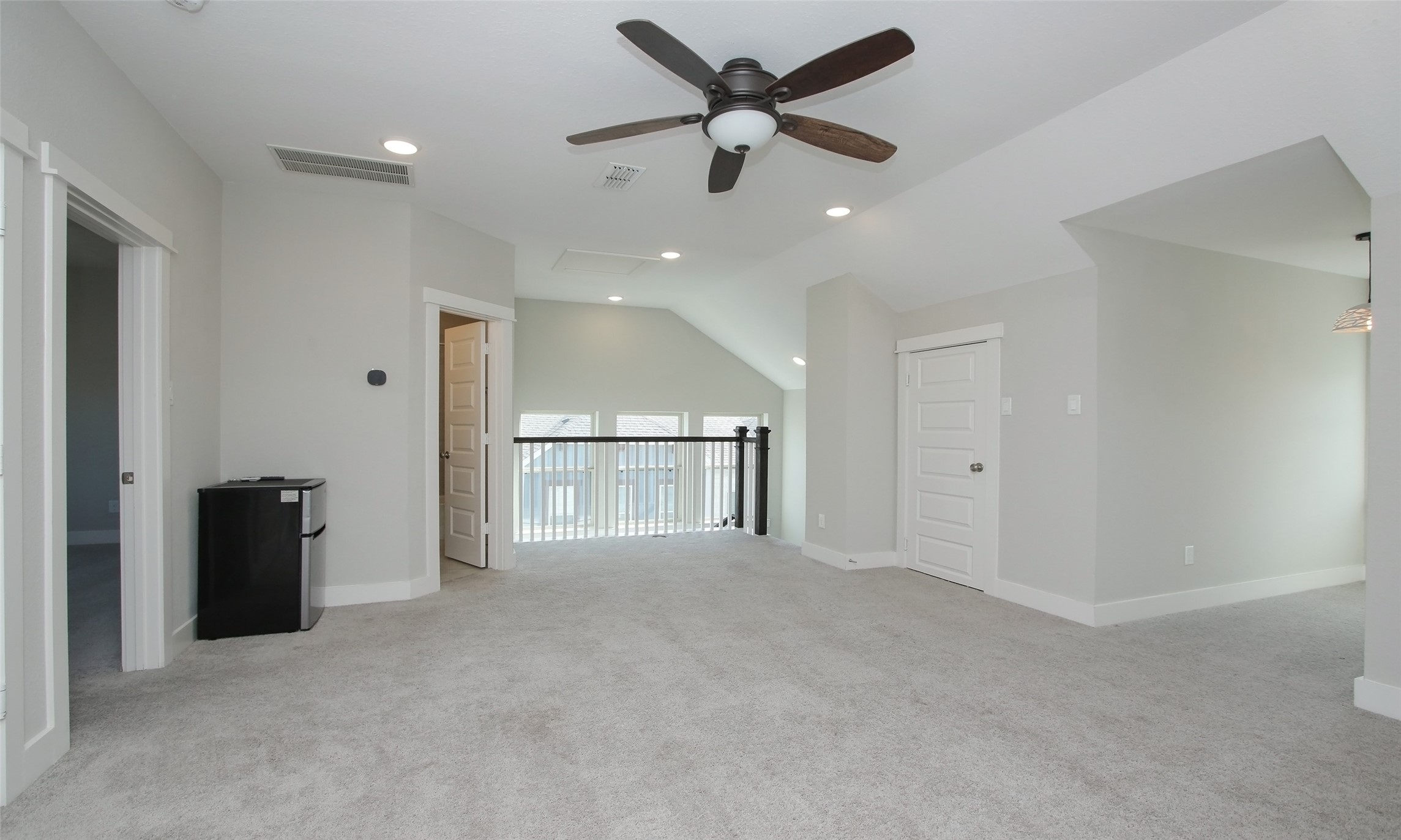 12502 Malachite Way Houston, TX 77077 - Photo 32 of 41 Alternate view of the game room with a guest bedroom on the left, access to the guest bathroom and stairway to the second floor