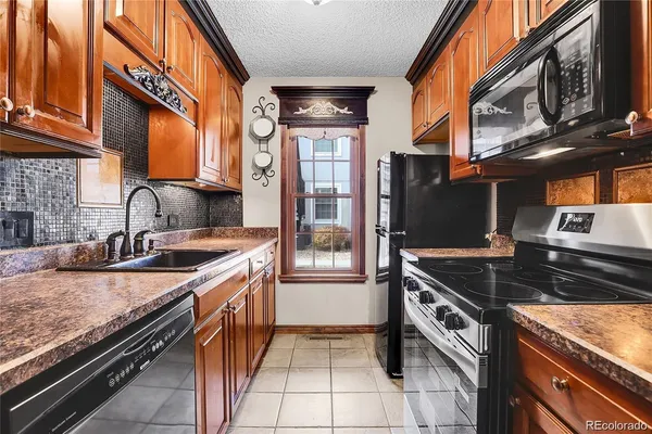 a kitchen with stainless steel appliances granite countertop a stove and a sink