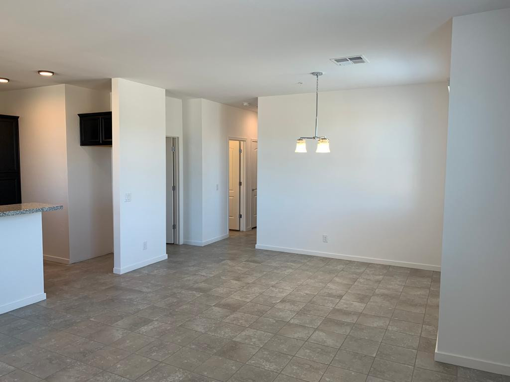 3900 East Baseline Road, Unit 118 Phoenix, AZ 85042 - Photo 6 of 32 a view of an empty room with a fan