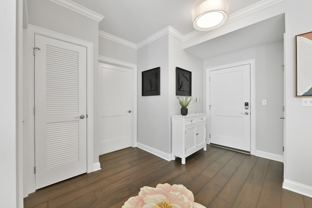 635 Old Post Road, Unit 2209 Sharon, MA 02067 - Photo 13 of 42 an empty room with wooden floor and white walls
