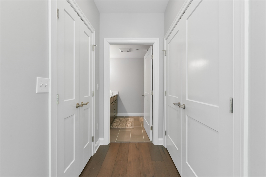 635 Old Post Road, Unit 2209 Sharon, MA 02067 - Photo 14 of 42 a view of a hallway with wooden floor