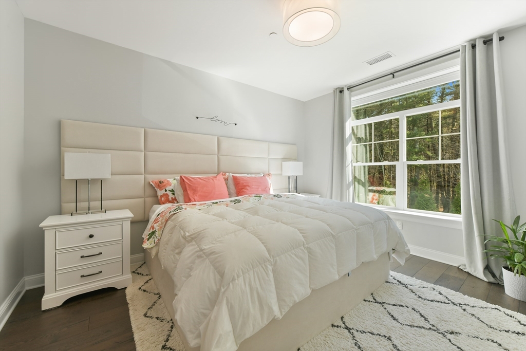635 Old Post Road, Unit 2209 Sharon, MA 02067 - Photo 15 of 42 a bed sitting in a bedroom next to a window