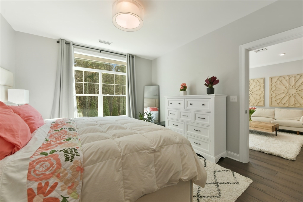635 Old Post Road, Unit 2209 Sharon, MA 02067 - Photo 17 of 42 a bedroom with a bed and a window