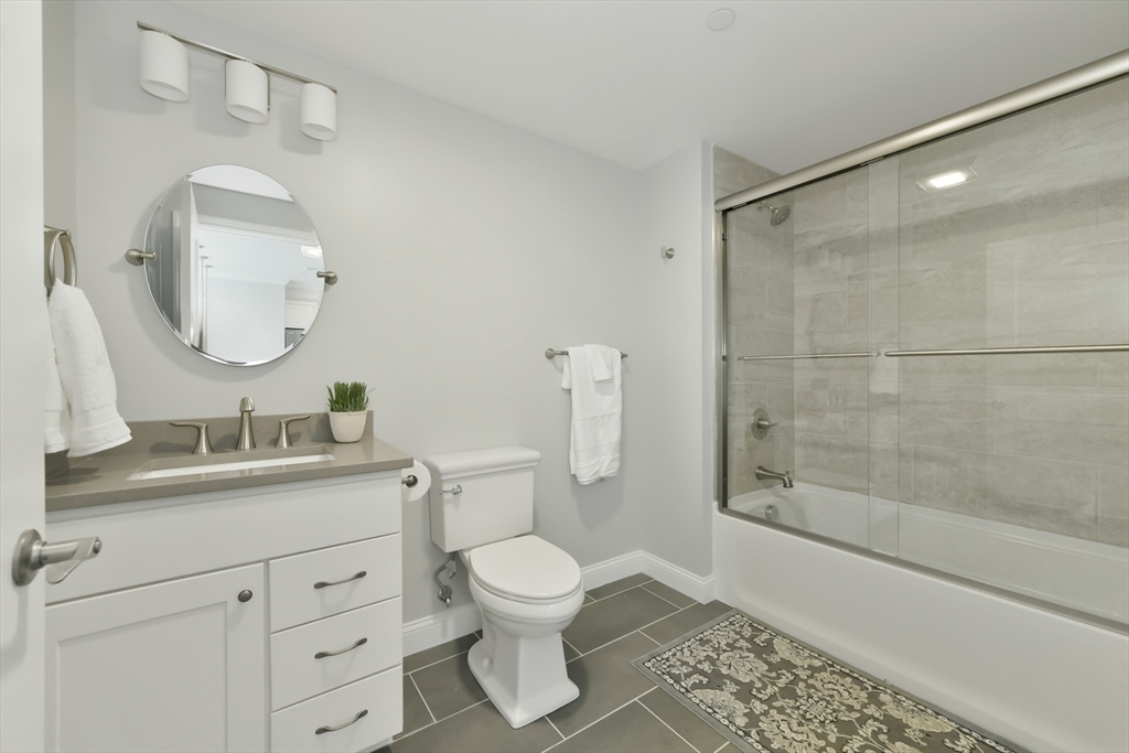 635 Old Post Road, Unit 2209 Sharon, MA 02067 - Photo 24 of 42 a bathroom with a toilet a sink and shower