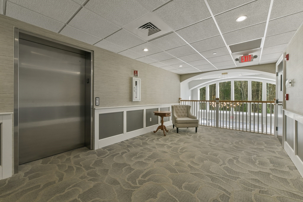 635 Old Post Road, Unit 2209 Sharon, MA 02067 - Photo 25 of 42 a view of a hallway with an empty room