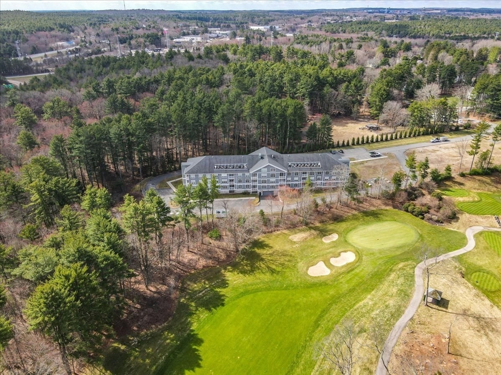 635 Old Post Road, Unit 2209 Sharon, MA 02067 - Photo 40 of 42 an aerial view of a house with a yard and lake view