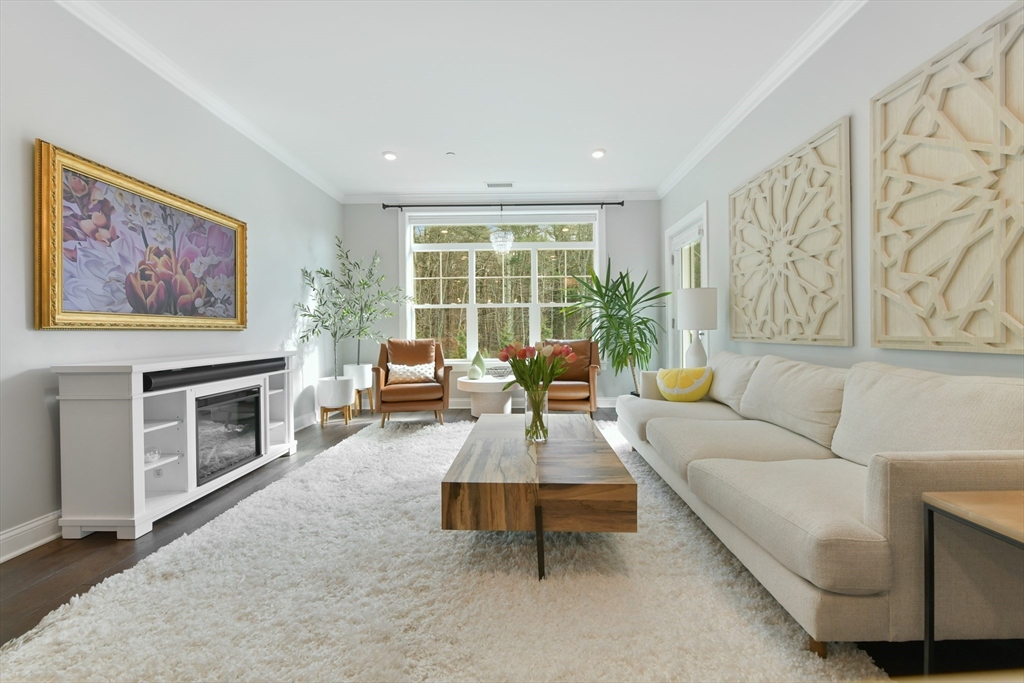 635 Old Post Road, Unit 2209 Sharon, MA 02067 - Photo 10 of 42 a living room with furniture and a fireplace