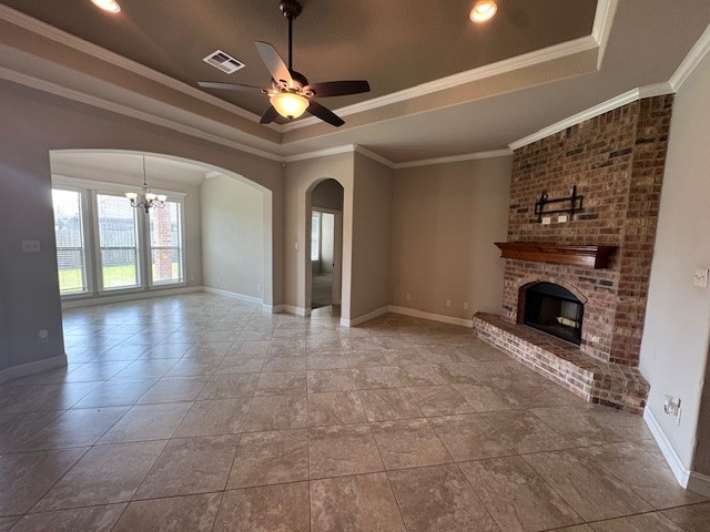 8305 Raintree Drive College Station, TX 77845 - Photo 4 of 9 a view of a livingroom with a fireplace a chandelier and windows
