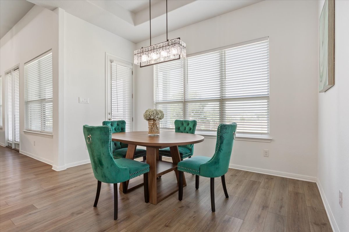 3625 Garrano Bend Leander, TX 78641 - Photo 12 of 38 The dining area features rich hardwood flooring and a stylish chandelier.