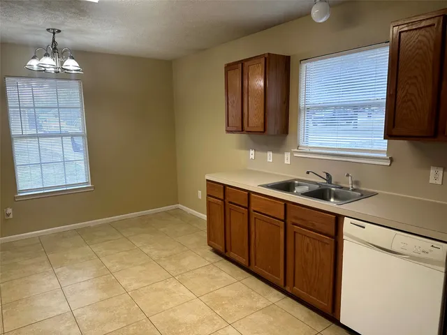 a kitchen with a sink cabinets and window