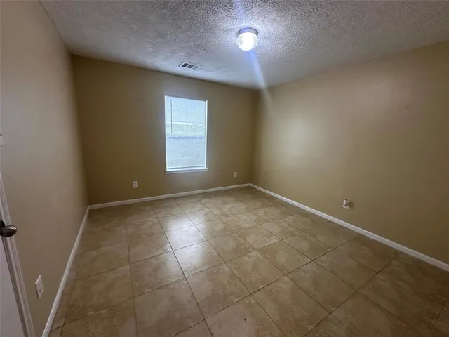 an empty room with a empty space and windows